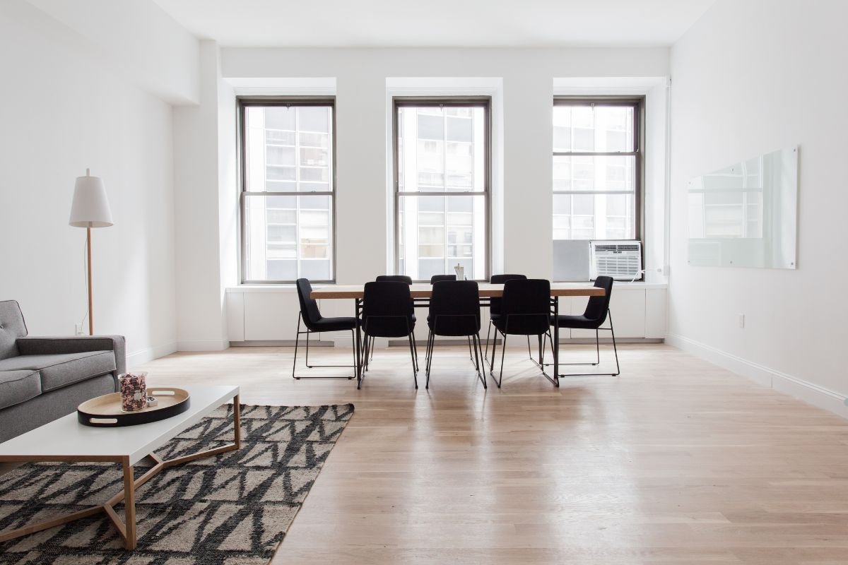 A cozy living room featuring a couch, table, and chairs, showcasing elegant flooring service.
